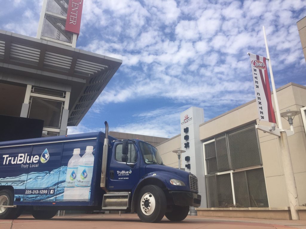 TruBlue Water delivery truck on a downtown delivery